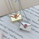 A Copper Envelope Necklace Inlaid With Red Hearts Design